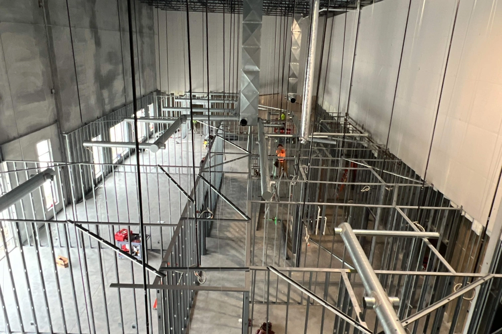 interior of office area under construction with framed out offices and hallway